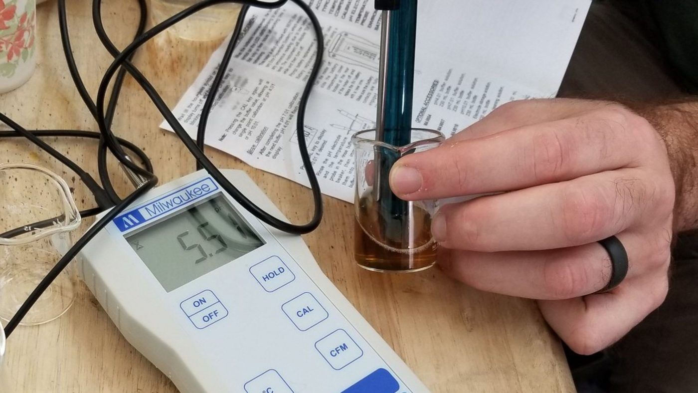 Image of diy distilling checking the ph of finished fermentation