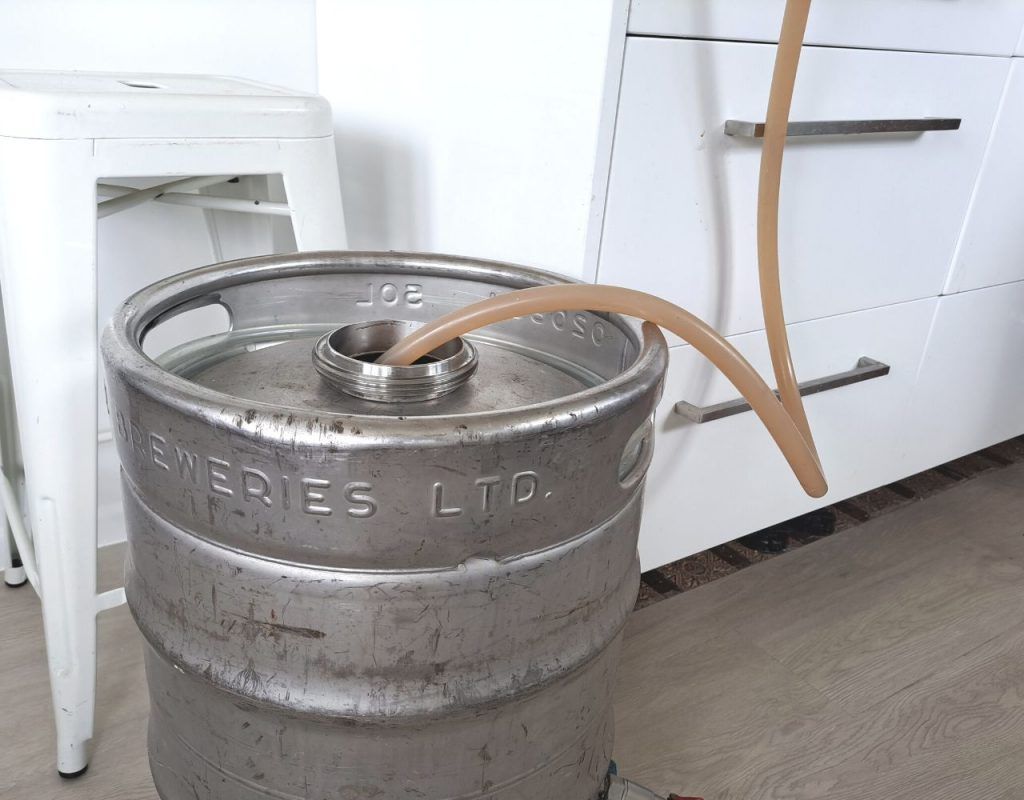 Image of diy distilling filling the fermenter with whiskey wash