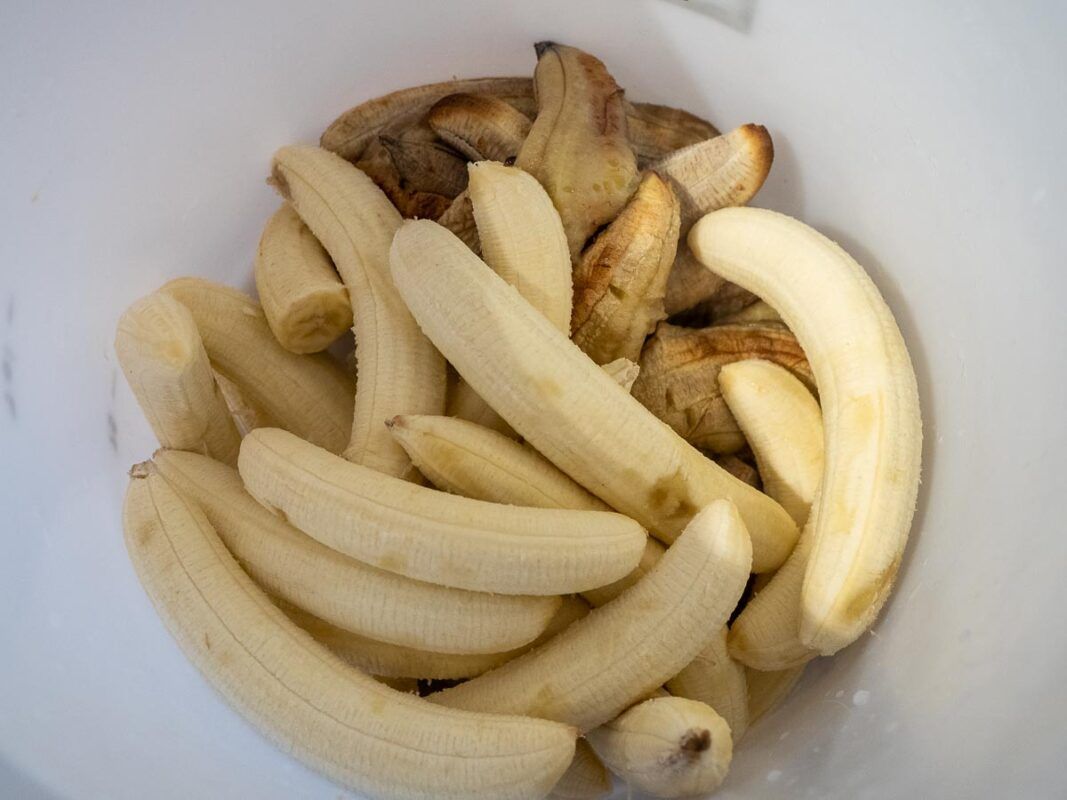 Image of diy distilling adding the bananas to the fermenter